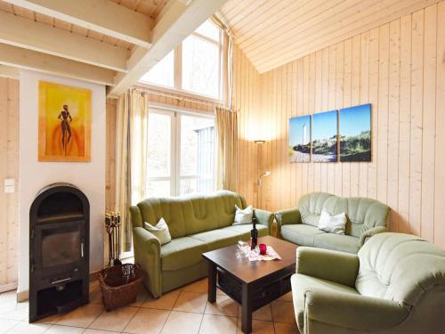 a living room with two couches and a fireplace at Ferienhaus Ostseeblick 274 in Baabe