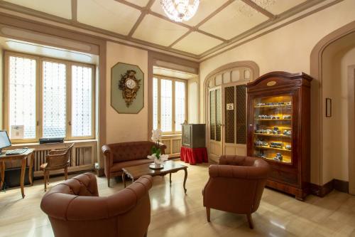 a living room filled with furniture and a large window at Hotel Antica Dogana in Turin
