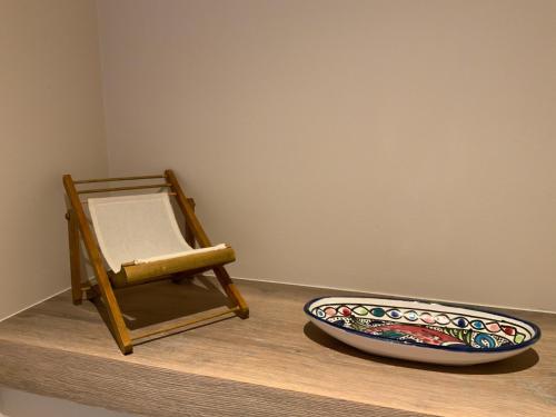 a chair and a bowl sitting on a counter at Genieten van de Vlaamse kust met prachtig zeezicht in De Haan
