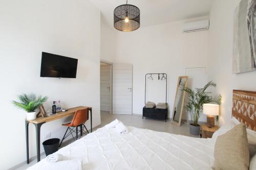 a bedroom with a bed and a tv at Travel B&B in Pisa