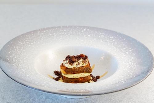 a piece of cake on a plate on a table at Pantelleria Dream Resort in Pantelleria