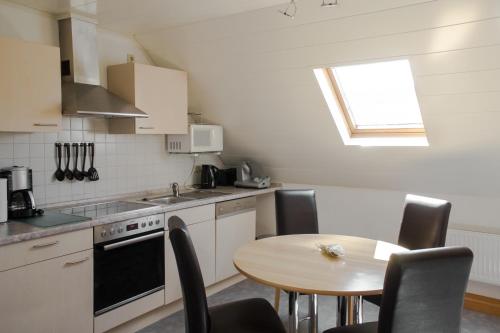 a kitchen with a table and a table and chairs at Gästehaus Edith, 4-Sterne, 2-4 Personen in Trittenheim
