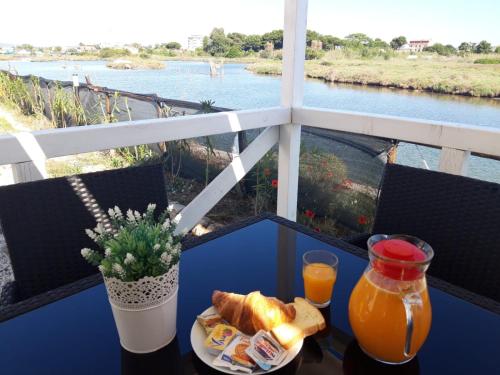 a table with a plate of bread and orange juice at Torre del Lago in Foce Varano