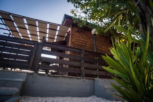 a set of stairs leading up to a wooden fence at ΛΩΤΟΣ in Kavala