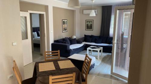 a living room with a blue couch and a table at Villa Mishe in Ohrid