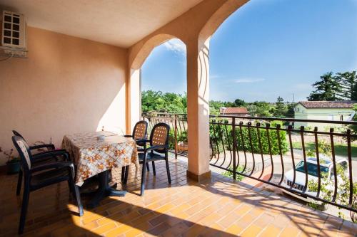 a patio with a table and chairs on a balcony at Apartments Dara in Umag