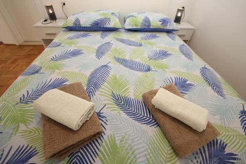 a bedroom with a bed with two towels on it at Apartment Luigi in Poreč