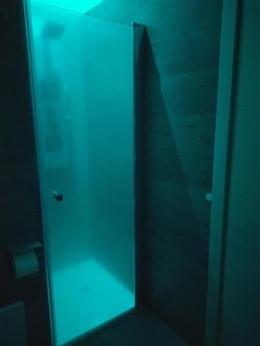 a glass door of a shower stall with a shadow at A Polignano Rooms in Polignano a Mare