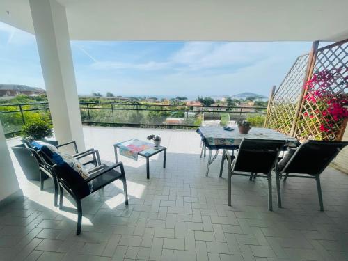 a patio with a table and chairs and a view at Villa Cristina in Formia