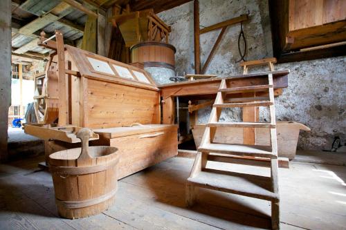 a room with a wooden kitchen with a ladder at Angerle Hof in Nova Levante