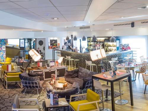 a store with couches and tables and chairs at Novotel Paris Rueil Malmaison in Rueil-Malmaison