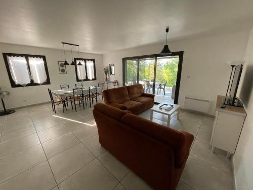 a living room with a couch and a table at Gîtes des Campanes in Saint Alban Auriolles