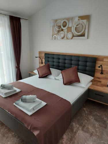 a bedroom with a large bed with towels on it at Apartmani Delač in Vodice