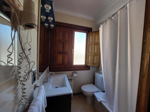 a bathroom with a sink and a toilet at Hosteria Picos De Europa in Potes