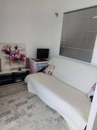 a bedroom with a bed and a television and a window at AJACCIO VUE IMPRENABLE APPT 3 P POUR 4 OU 5 PERSONNES SANGUINAIRES 300M PLAGES ET MERPERSONNES in Ajaccio