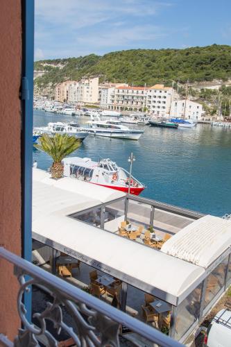 a view from a balcony of a boat in a harbor at Best Western Hotel du Roy d'Aragon in Bonifacio