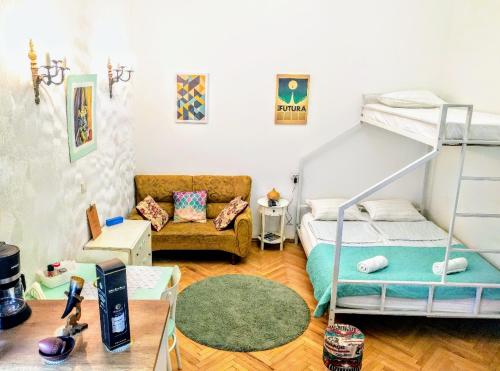 a room with a bunk bed and a couch at Old Town Studio With Picture Perfect Terrace ! in Tbilisi City