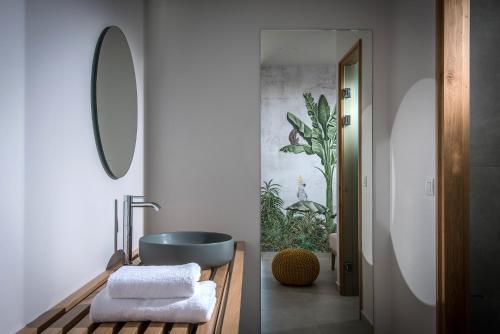 a bathroom with a sink and a bath tub at Enorme Teatro Beach in Amoudara Herakliou