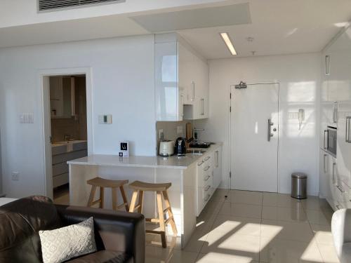 a kitchen with a couch and a counter in a room at Urban Awe Apartment-iTowers 23rd Floor in Gaborone