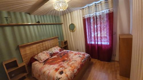 a bedroom with a bed and a red door at Gites Du Ladhof in Colmar