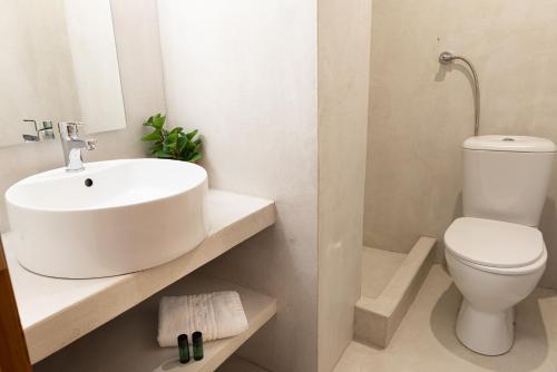 a white bathroom with a sink and a toilet at Germany in Olympiada