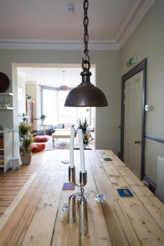 a dining room with a table with three candles on it at CloudZen in Kent