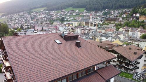 an overhead view of a town with a red roof at Hotel Garni Walter in Ortisei