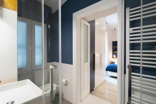 a bathroom with a white sink and a mirror at Corfu Town Twin Studios- Liston area in Corfu Town