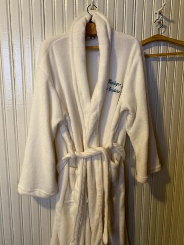 a white robe is hanging on a rack at Pousada Expedicionário Energias da Serra in Bom Jardim da Serra