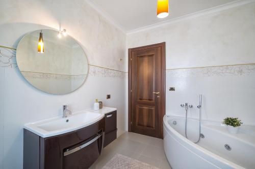 a bathroom with a tub and a sink and a bath tub at B&B Samilu' in Battipaglia