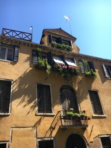 a building with flower boxes and windows on it at Attico con Altana in Venice
