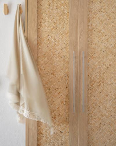 a wooden door with a cloth hanging on a wall at Mykonos Essence Adults Only in Ornos