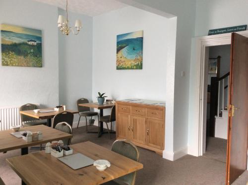 a dining room with two tables and chairs and a dining room at Frosty Towers in Llandudno