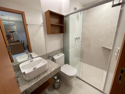 a bathroom with a toilet and a sink and a shower at Salinas Exclusive Resort in Salinópolis