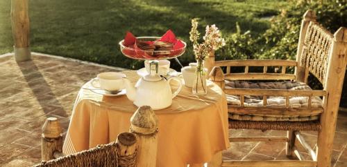 a table with a bowl of flowers on top of it at Casa Terzerie in Braccagni