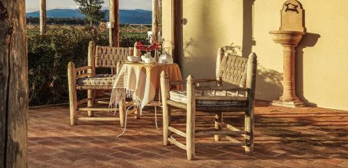 a table and two chairs and a table and a table and chairs at Casa Terzerie in Braccagni