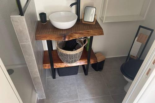 a bathroom with a wooden table with a sink at Studio Collobrières Vue sur village in Collobrières