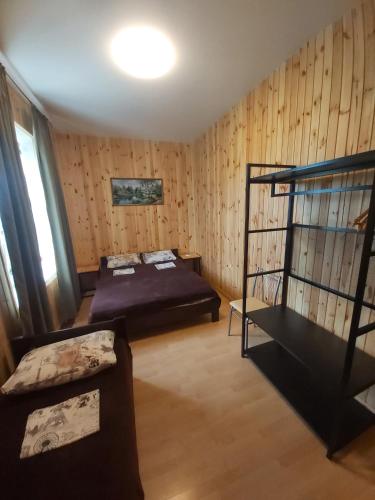 a room with a bed and a couch in it at Гостевой дом Вилла Босфор in Sanzhiyka