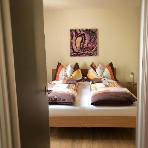 a bedroom with two beds with pillows on it at Alpina in Leukerbad