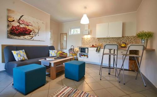 a kitchen and living room with a couch and a table at Arenda Apartamenty&Domki całoroczne in Sieraków