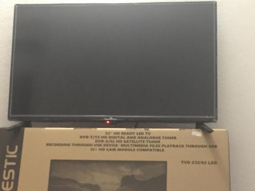 a flat screen tv sitting on top of a box at Airport-FREE shuttle till Night-BIG POOL-air cond-wi fi- sheets&linen wash machine ALL INCLUDED IN PRICE in Olbia