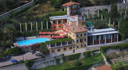 an aerial view of a large building with a sign at Hotel Palazzina in Gargnano