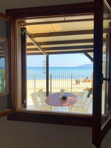 a view of a table and chairs from a window at Sea view in Artemis in Artemida