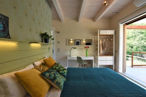 a bedroom with a blue bed and a desk at L'ALBEROCASA in Calenzano