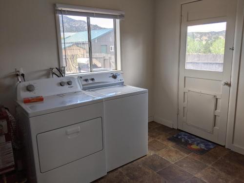 a kitchen with a washing machine and a window at Slackwater Inn in Buena Vista