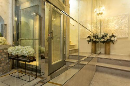 a lobby with flowers on a table in a building at Relais Venezia in Venice