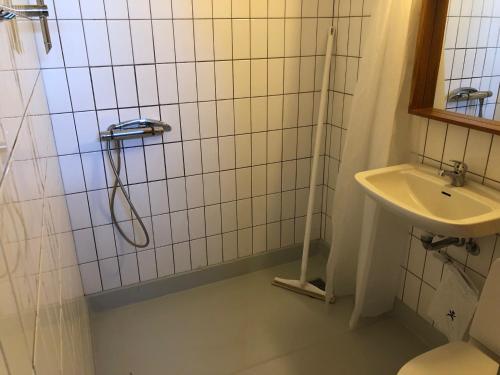 a bathroom with a shower and a sink at Danhostel Helsingør in Helsingør