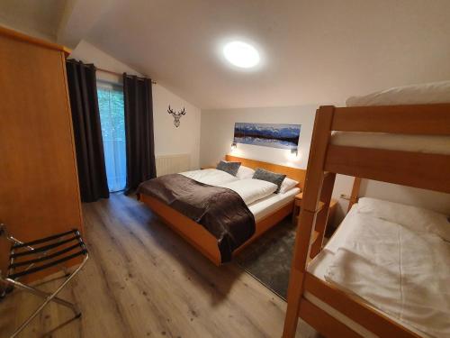a bedroom with a bed and two bunk beds at Glemmy Appartements inkl Sommercard in Viehhofen