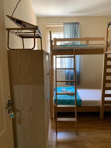 a room with two bunk beds and a ladder at Hostel Brazuca in Porto