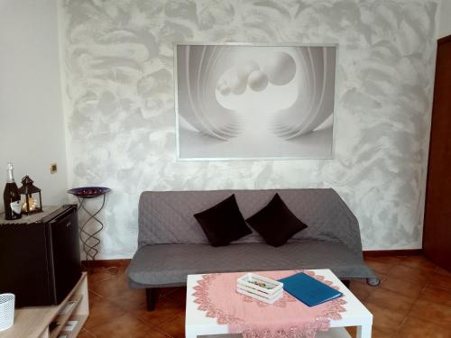 a living room with a couch and a table at Montegrappa Fly on in Crespano del Grappa